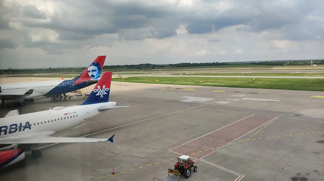 Air Serbia aircraft on the apron at Belgrade Nikola Tesla Airport, one tail carrying a portrait of Nikola Tesla