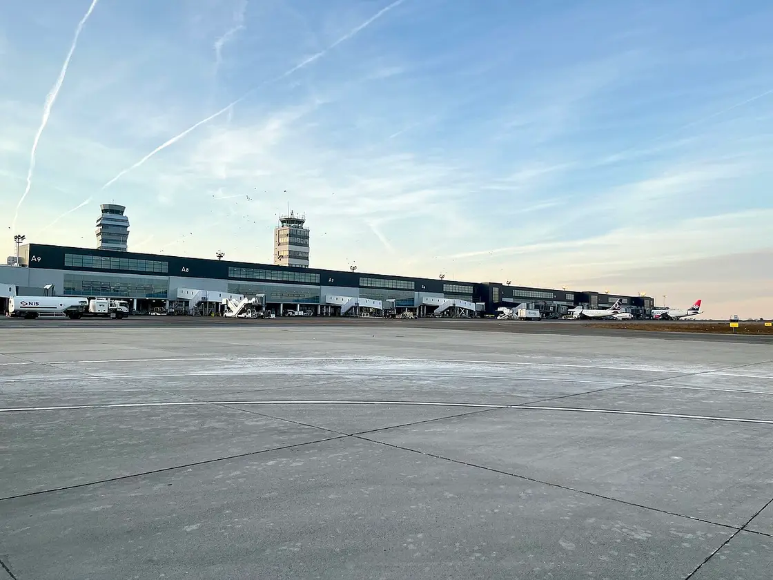 The terminal building and control towers of Belgrade Nikola Tesla Airport seen from the apron