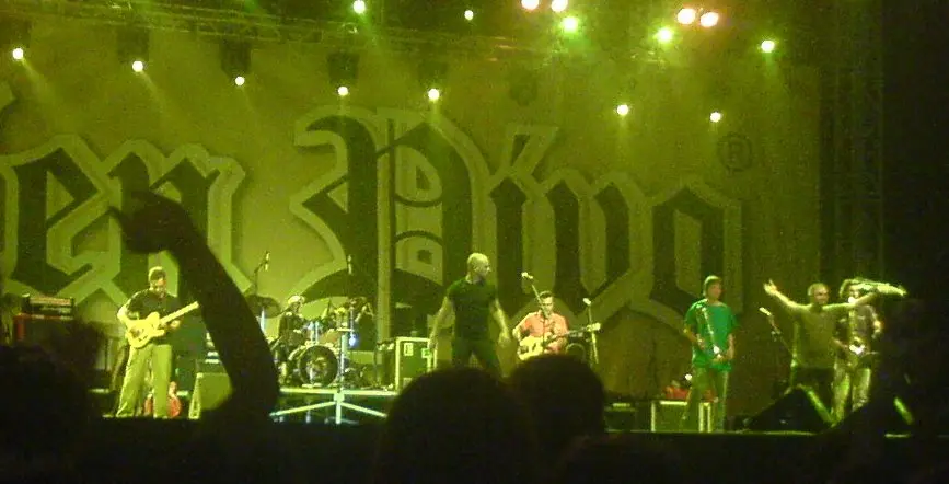 A rock band performing under green stage lighting at Belgrade Beer Fest