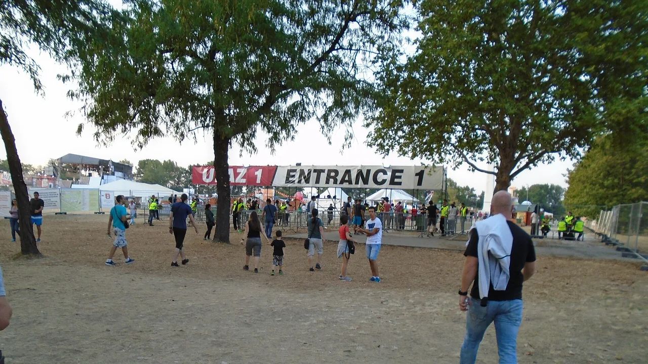 Festival-goers walking under the Entrance 1 banner at Belgrade Beer Fest, held each year in Ušće park