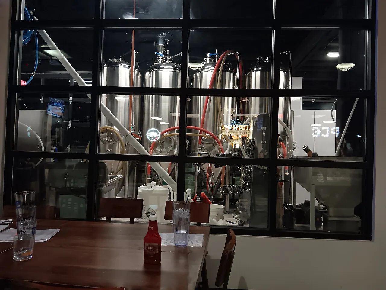 Stainless-steel fermentation tanks and piping in a small craft brewery