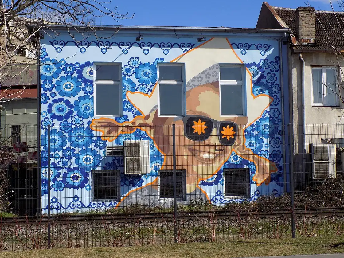 A large street-art mural on a building wall in the Savamala district of Belgrade