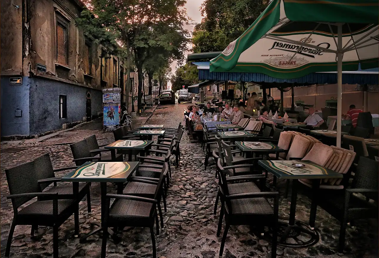 Cafe tables on the cobbles of Skadarlija, Belgrade old bohemian restaurant street, at dusk