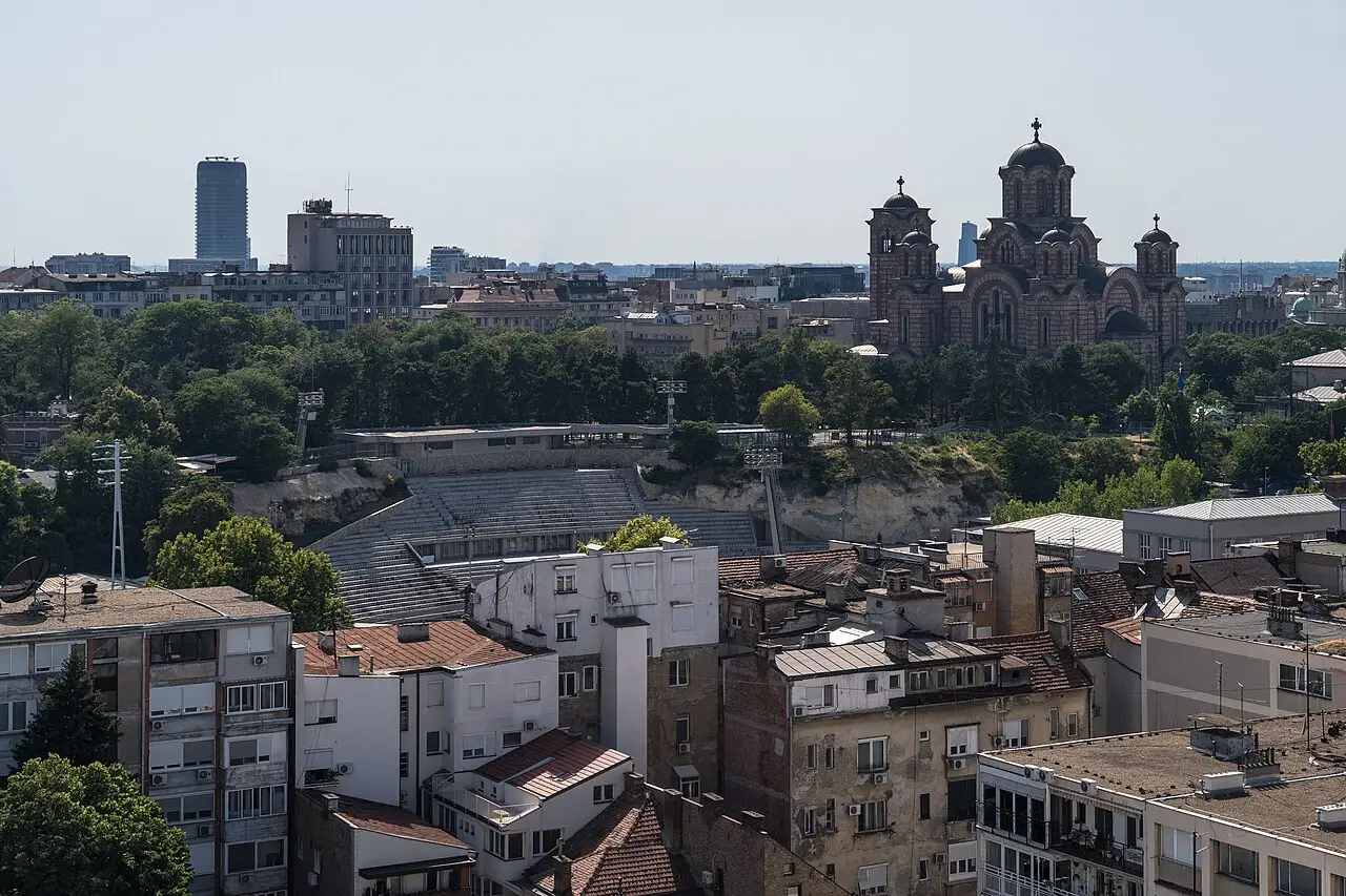 A rooftop view of central Belgrade with the Church of St Mark and an open-air amphitheatre among the buildings