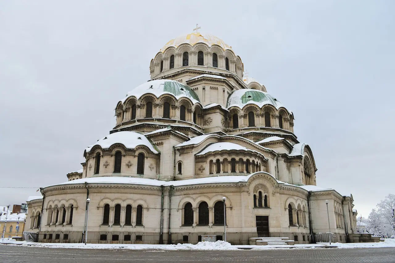 The gold-domed Alexander Nevsky Cathedral in Sofia under a light dusting of snow