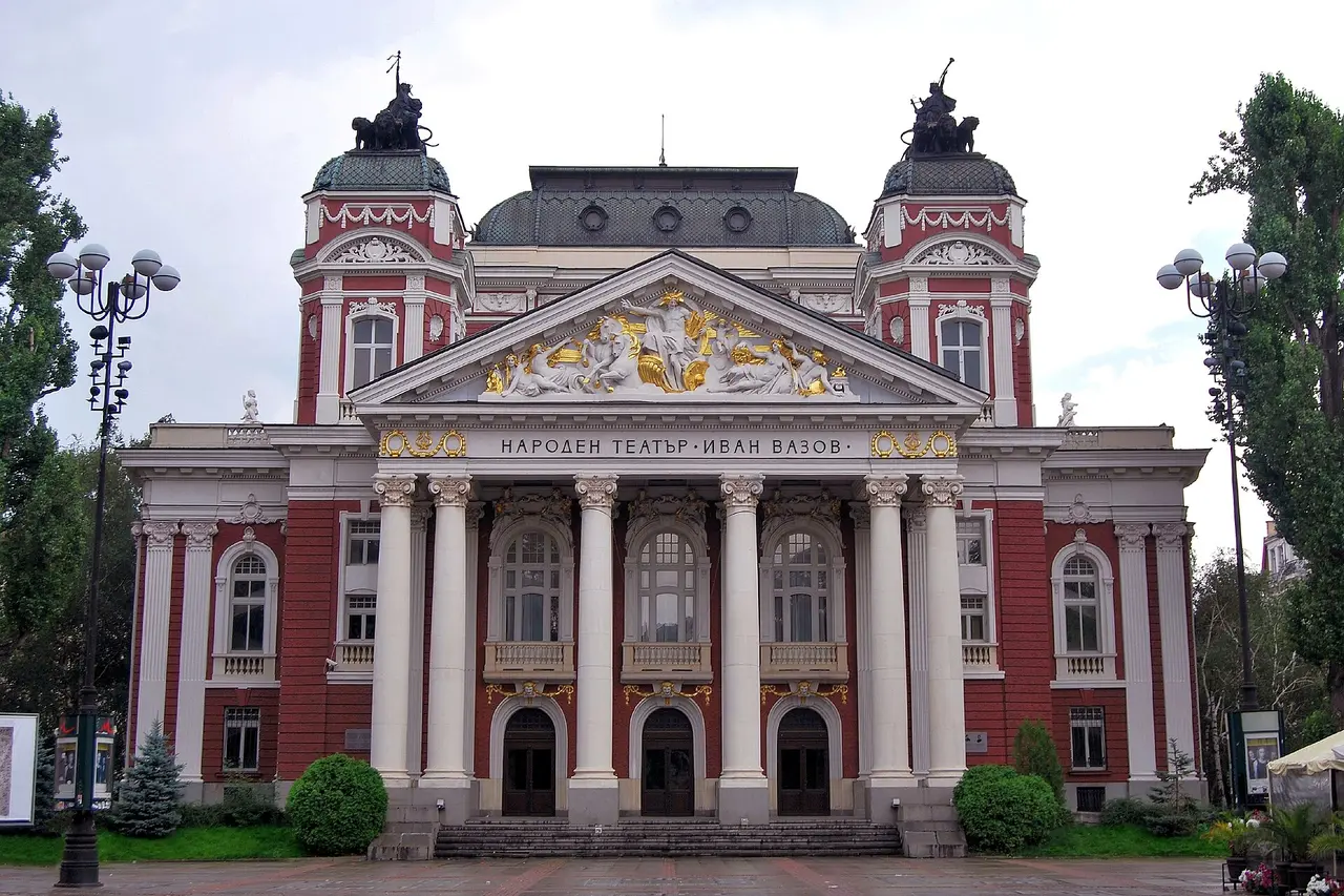 The red and white neoclassical facade of the Ivan Vazov National Theatre in central Sofia