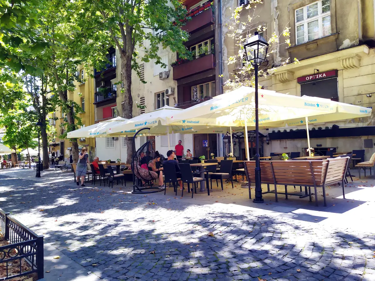 Cafe terraces with parasols and outdoor tables along Strahinjica Bana street in central Belgrade