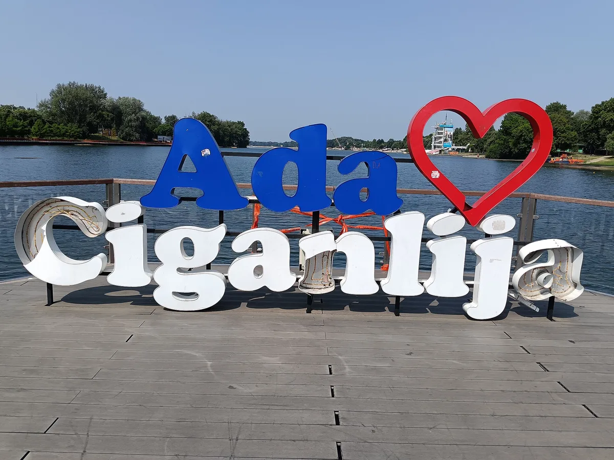 The Ada Ciganlija sign with a red heart on the wooden deck by the lake, Belgrade's riverside beach island