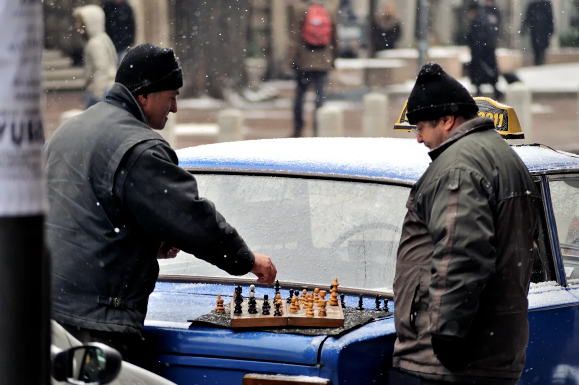 A Belgrade taxi driver waiting in his cab at a rank in the city