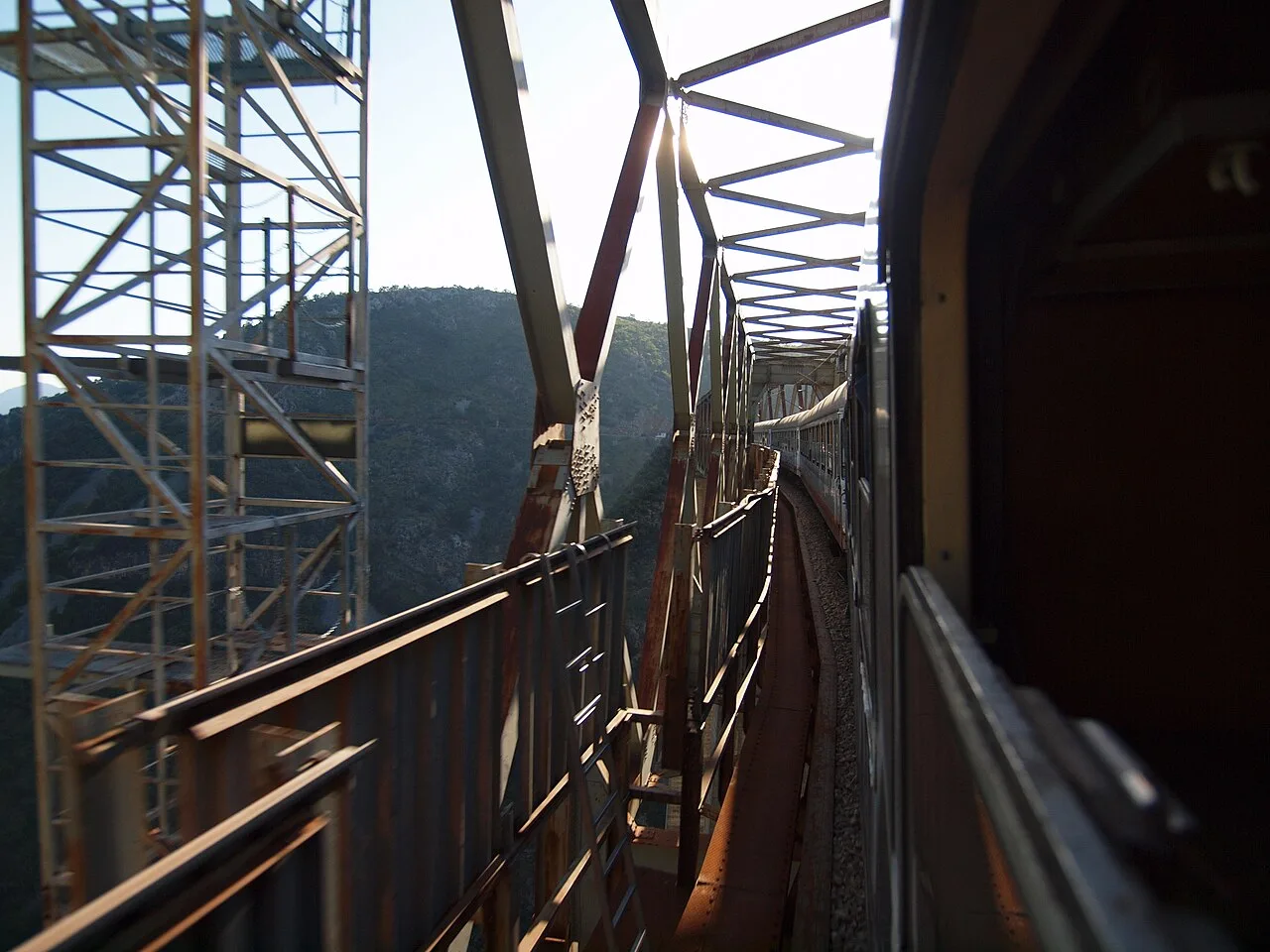 A train crossing the Mala Rijeka viaduct high above a forested gorge on the Belgrade to Bar railway