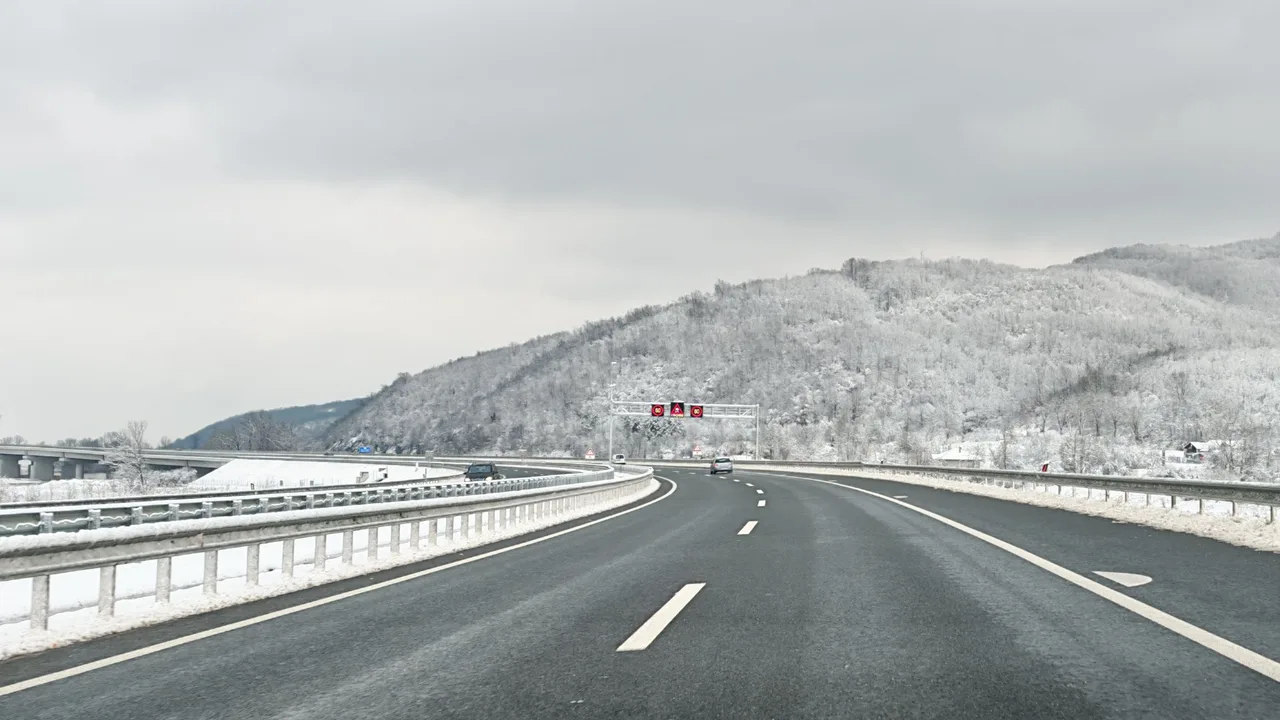 The A5 motorway in central Serbia on a winter day, with snow on the verges and frosted hills ahead