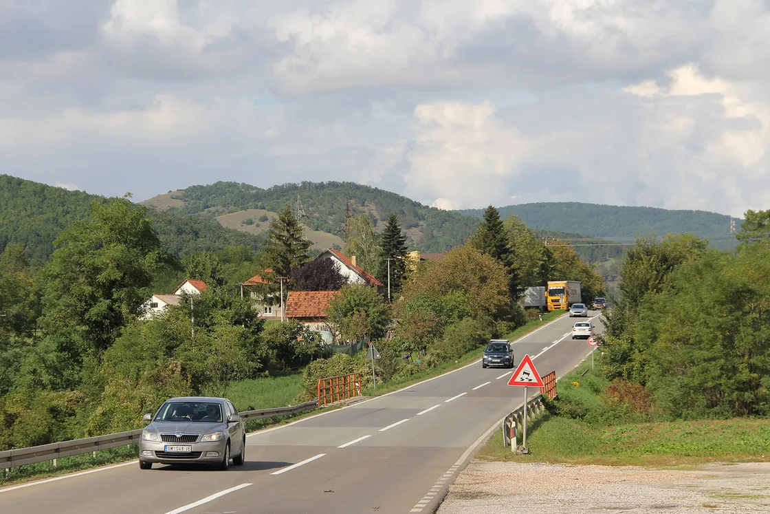 Cars and a lorry on the two-lane Ibar trunk road at Brđani in central Serbia