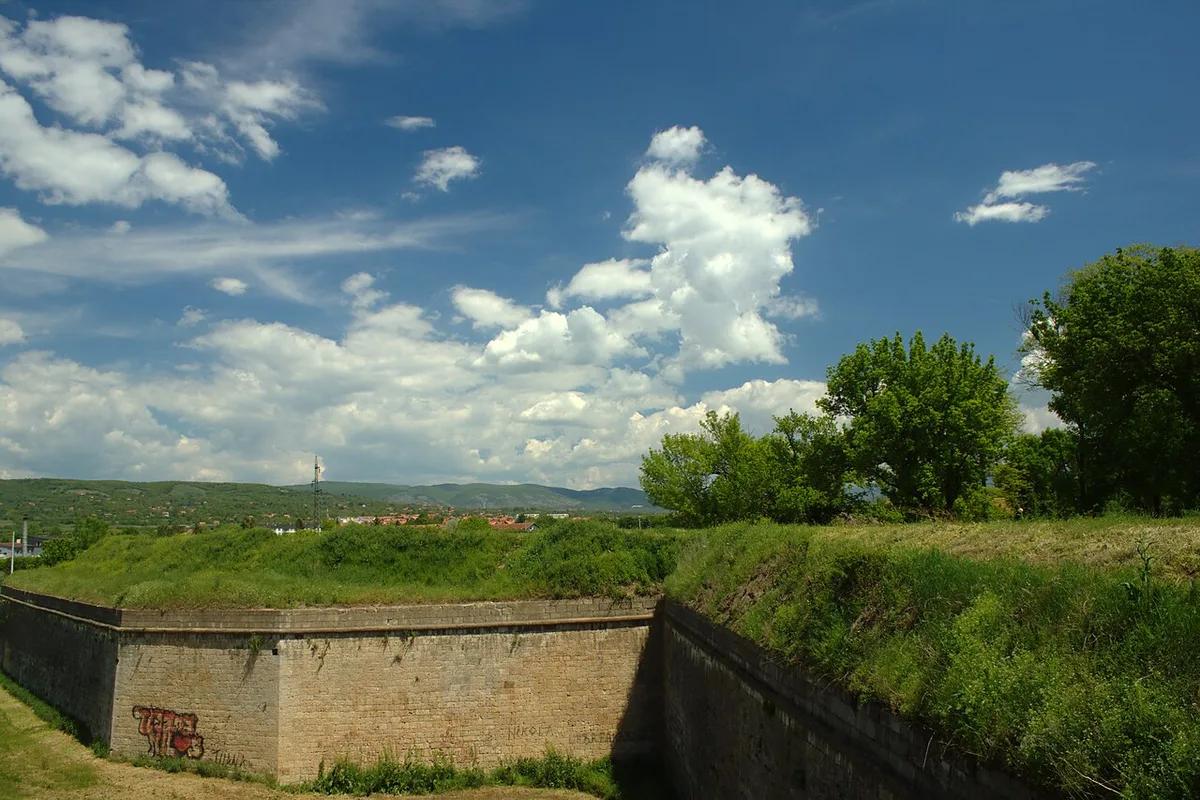 The grassed bastion walls of Niš Fortress with the hills of southern Serbia beyond