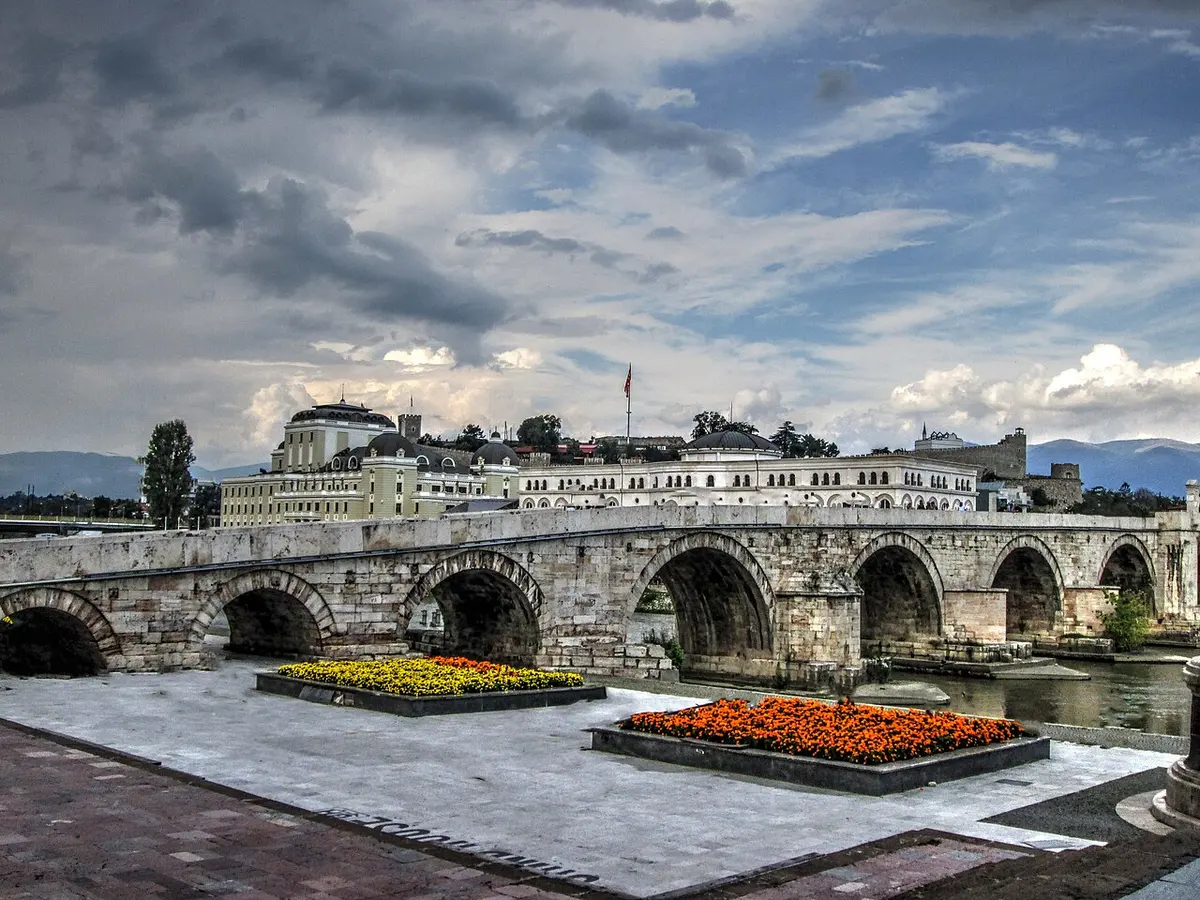 The old Stone Bridge over the Vardar river in Skopje, with the city behind