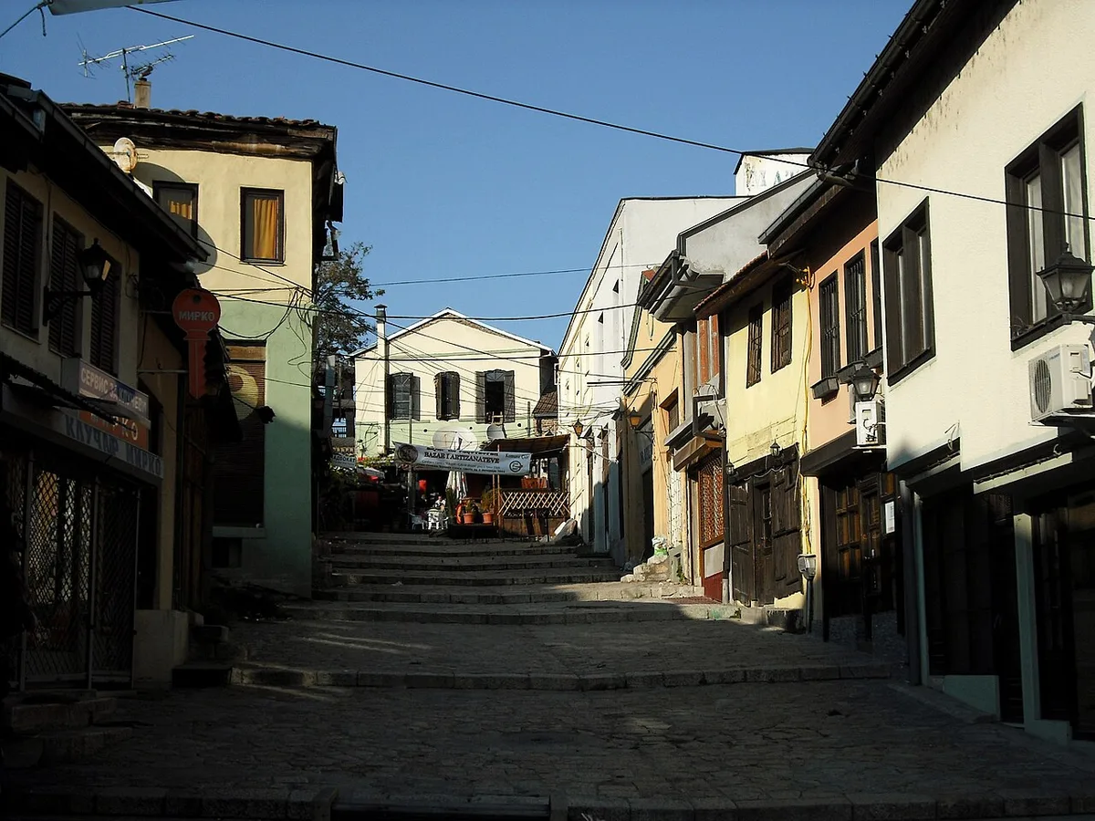 A cobbled lane of the Old Bazaar in Skopje with low shopfronts and stone buildings