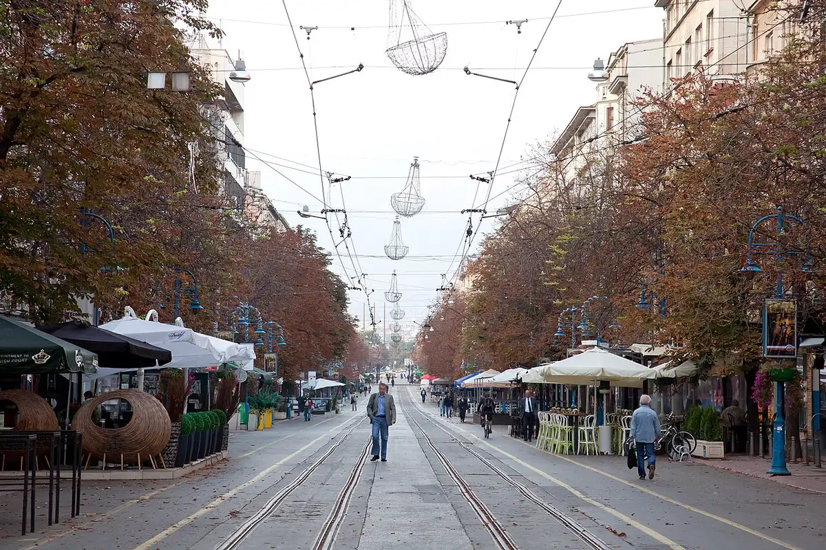 Pedestrians on Vitosha Boulevard in central Sofia with Vitosha mountain rising behind