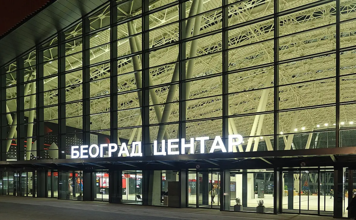 The lit glass facade of Beograd Centar station at night, the terminus locals call Prokop