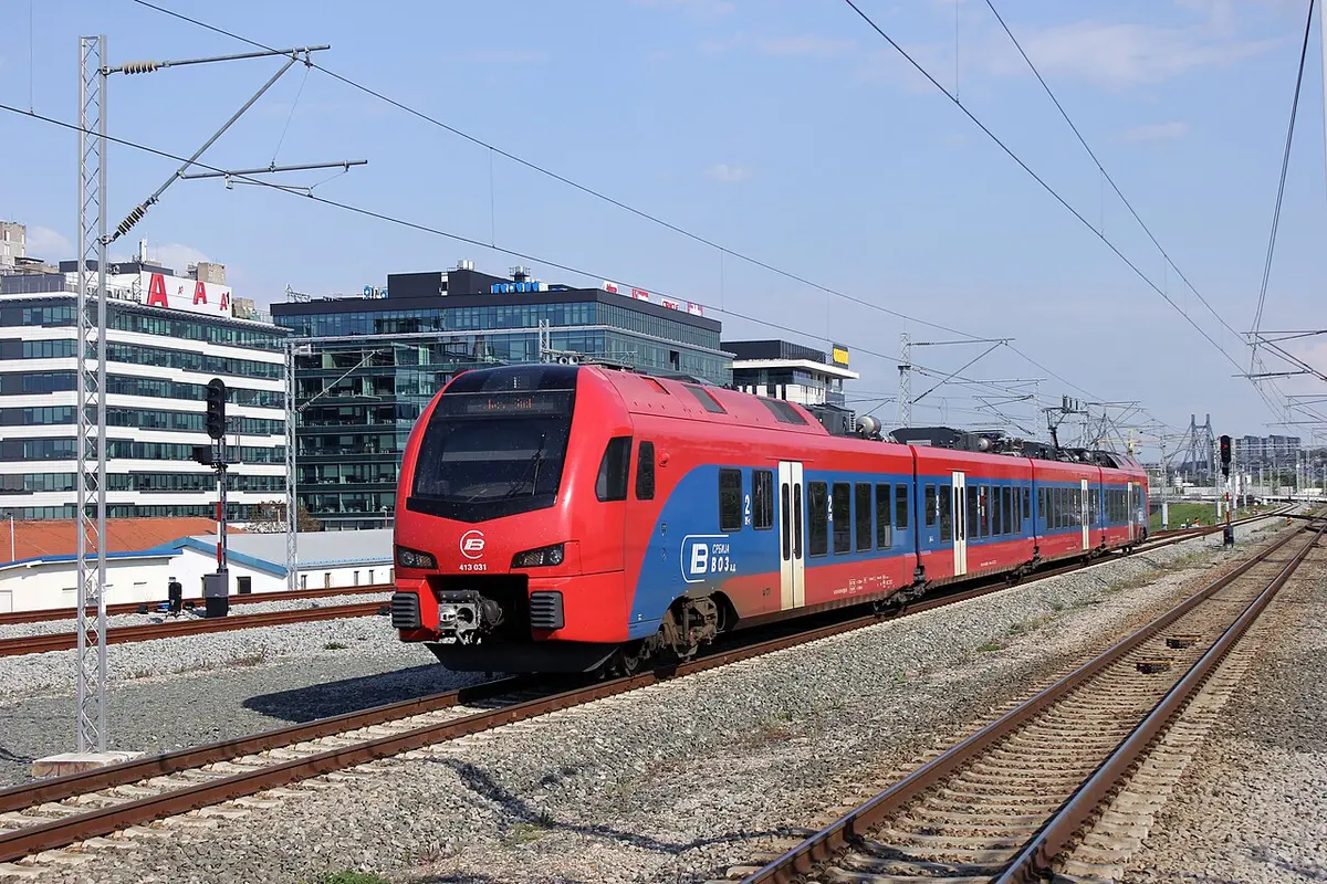 A red-and-blue Srbija Voz Soko high-speed train on the line near Belgrade