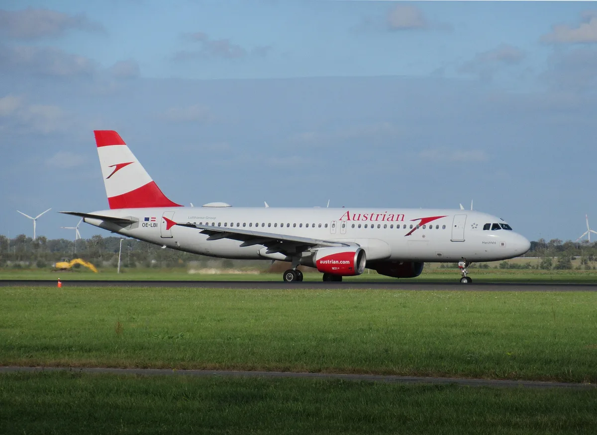An Austrian Airlines Airbus A320 in the airline red-and-white livery on the ground