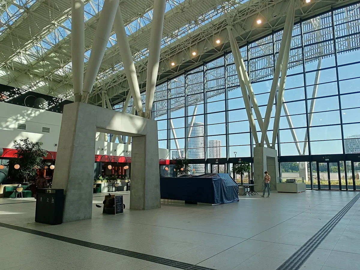 The bright modern concourse of Beograd Centar (Prokop) station, with the Belgrade Tower seen through the glass