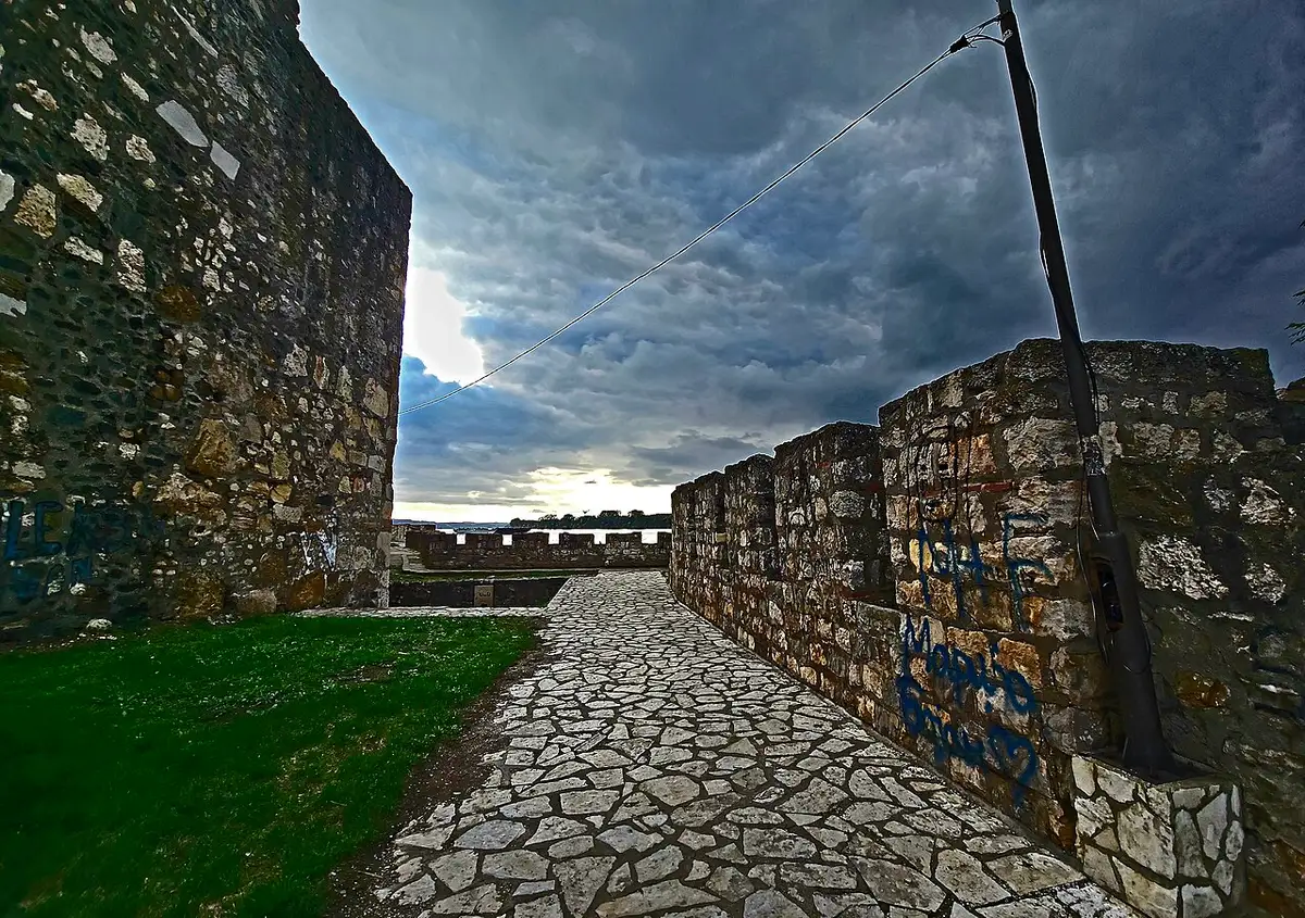 The stone ramparts of Smederevo Fortress on the Danube under a dramatic sky