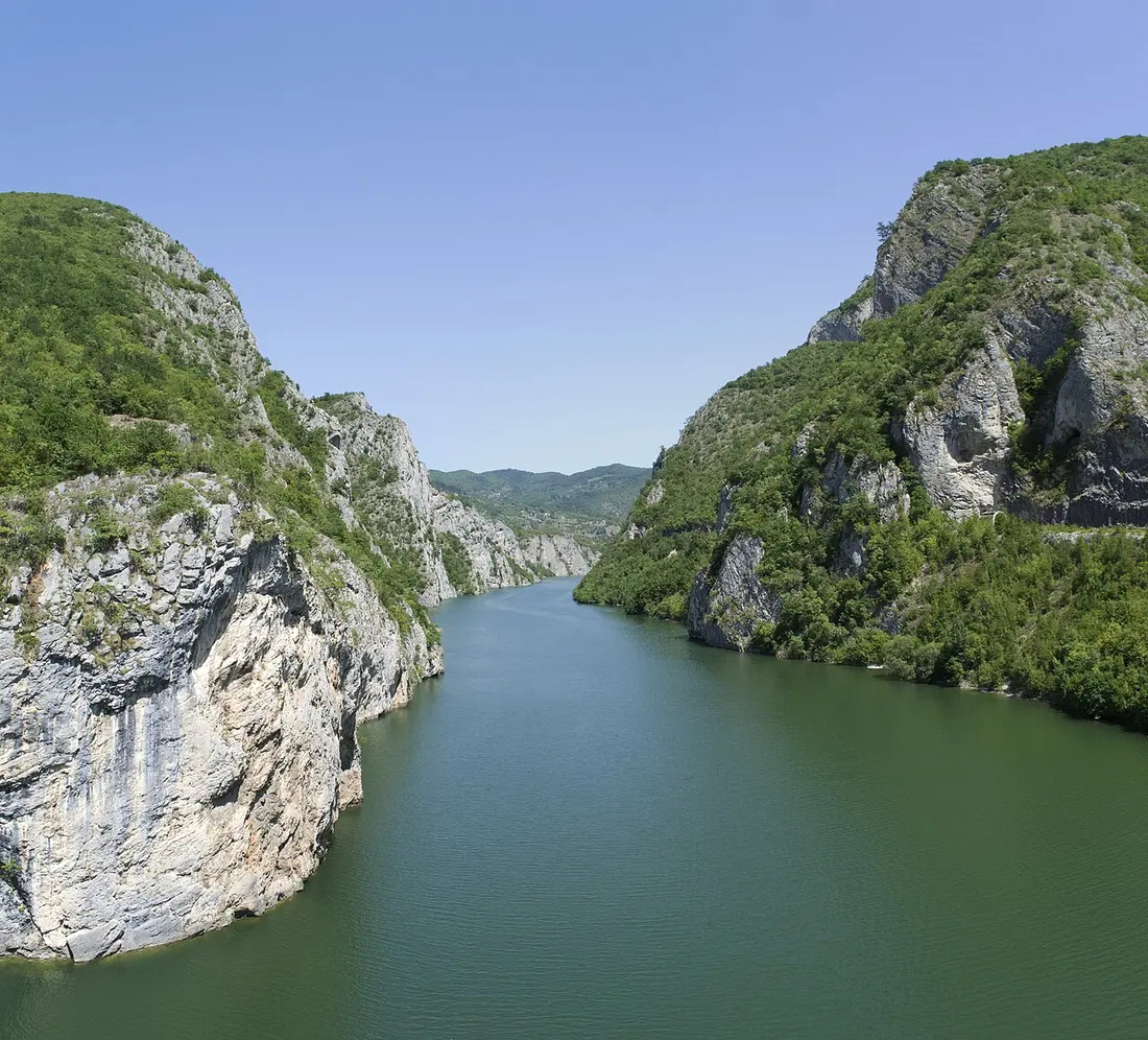 The deep green Drina river canyon with forested cliffs dropping to the water