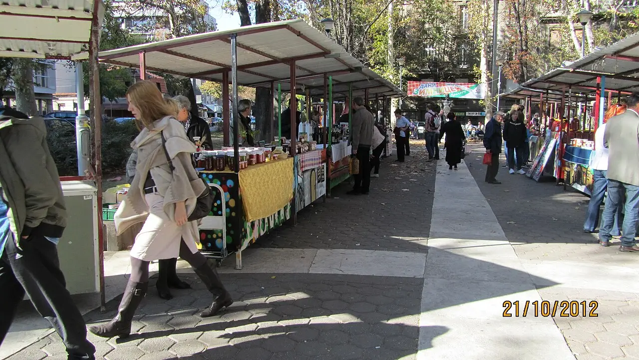 A street market with stalls under trees on a pedestrian street in the Vracar district of Belgrade