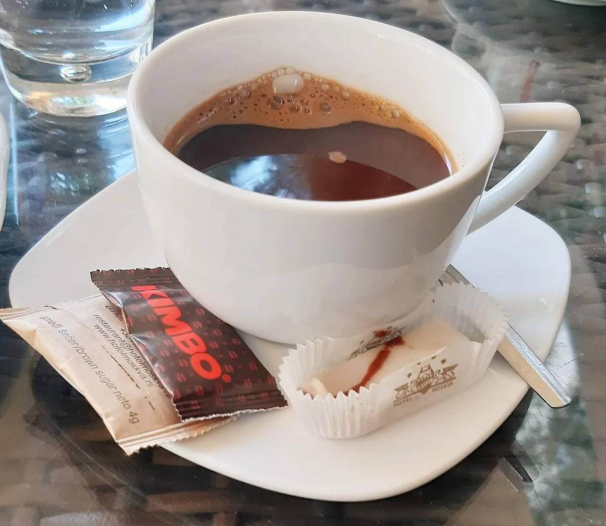 A cup of traditional Serbian domaća kafa coffee served with a copper pot