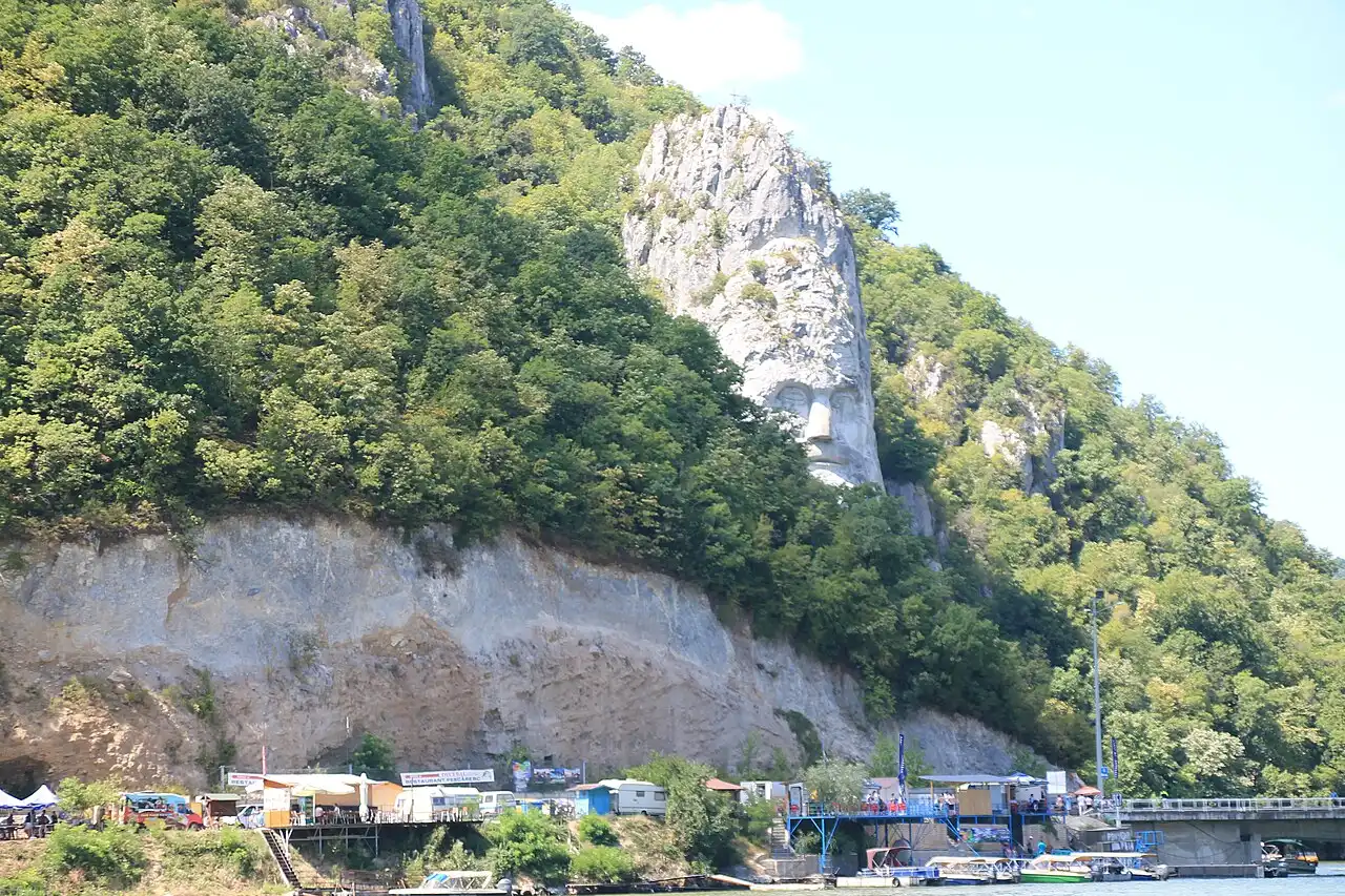 Rock sculpture of Decebalus on the Romanian bank, seen from the water on an Iron Gate boat ride