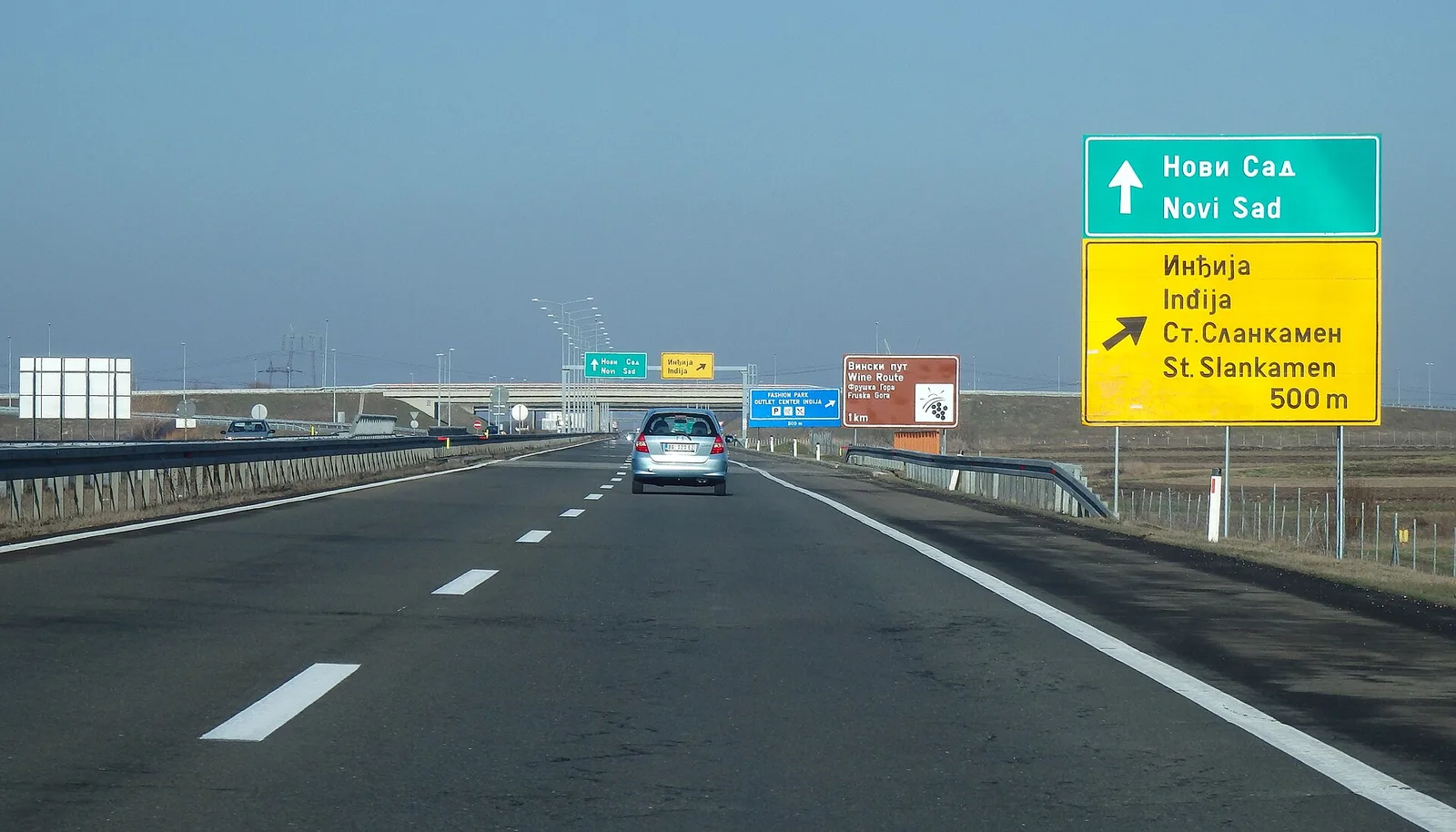 The E75 motorway running through open Serbian countryside under a clear sky