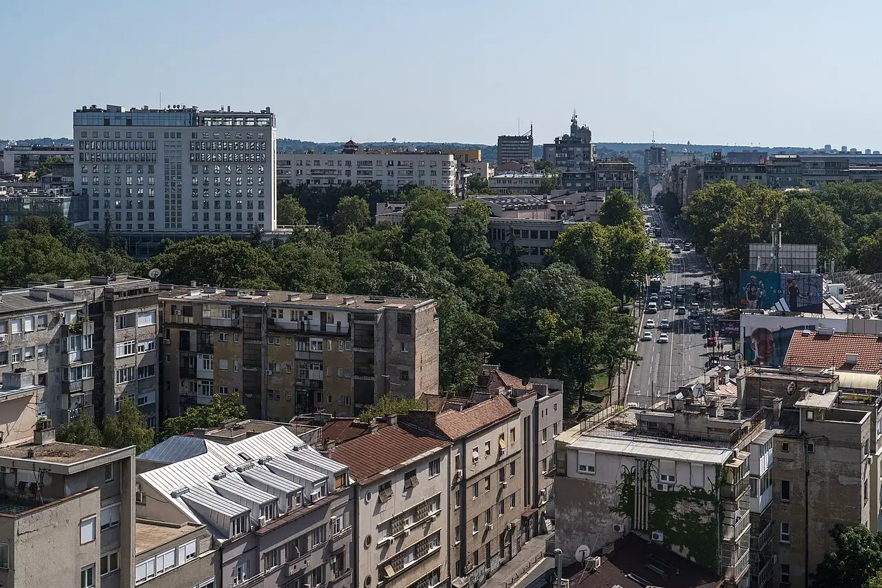 Rooftop view over central Belgrade and a tree-lined boulevard, the start of the eastern Serbia loop