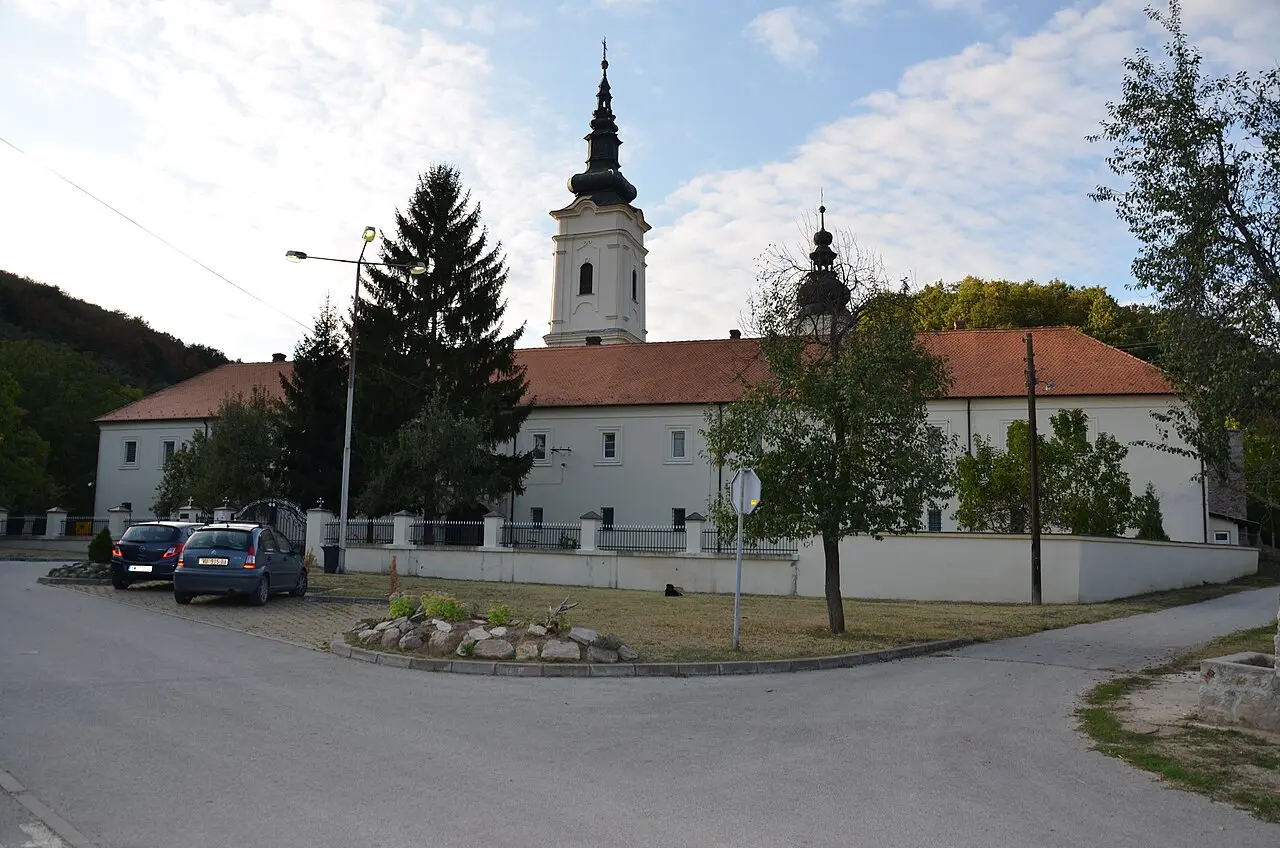 The tall baroque bell tower and church of Jazak monastery on the southern slopes of Fruska Gora