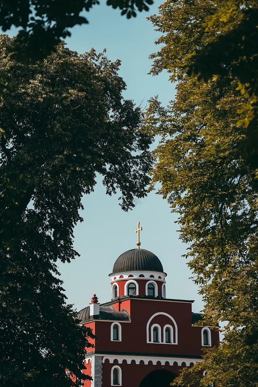 The tall white bell tower rising above Krusedol monastery walls on Fruska Gora