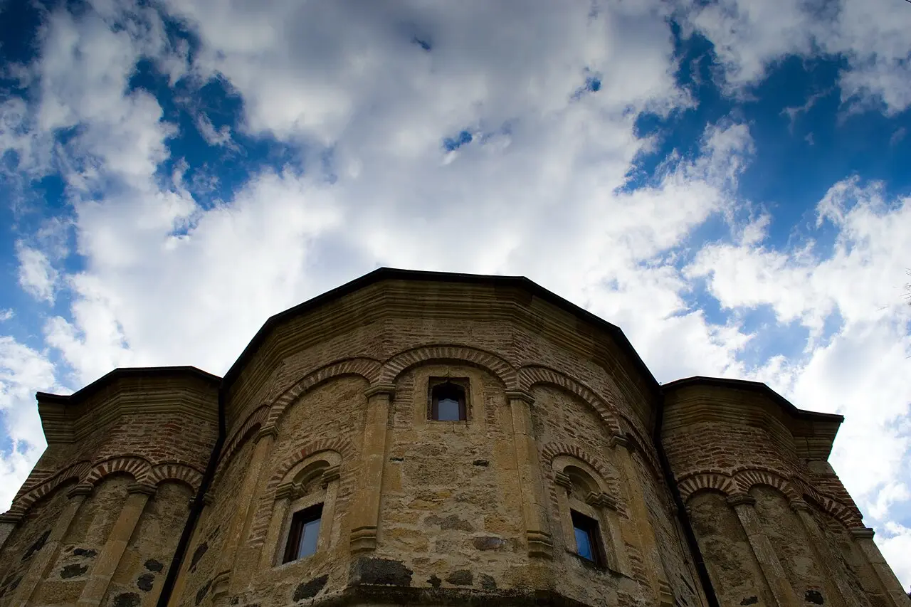 The domed church of Novo Hopovo monastery seen across its grassy courtyard