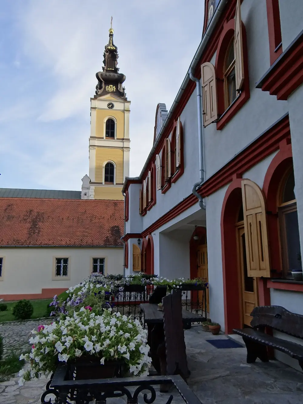 The Grgeteg monastery church tower rising above its walls on Fruška Gora