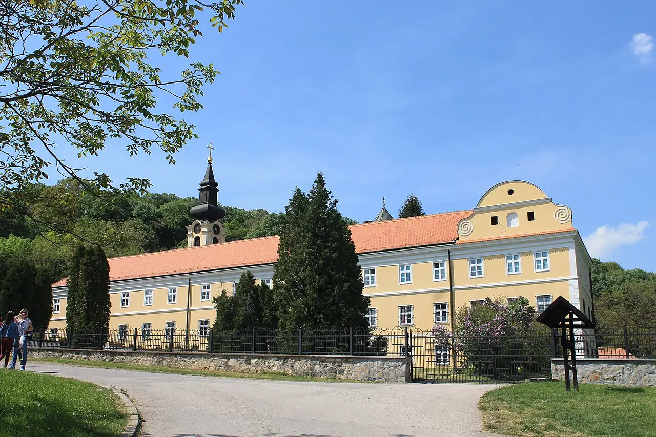 The domed church of Novo Hopovo monastery behind its walls on Fruška Gora