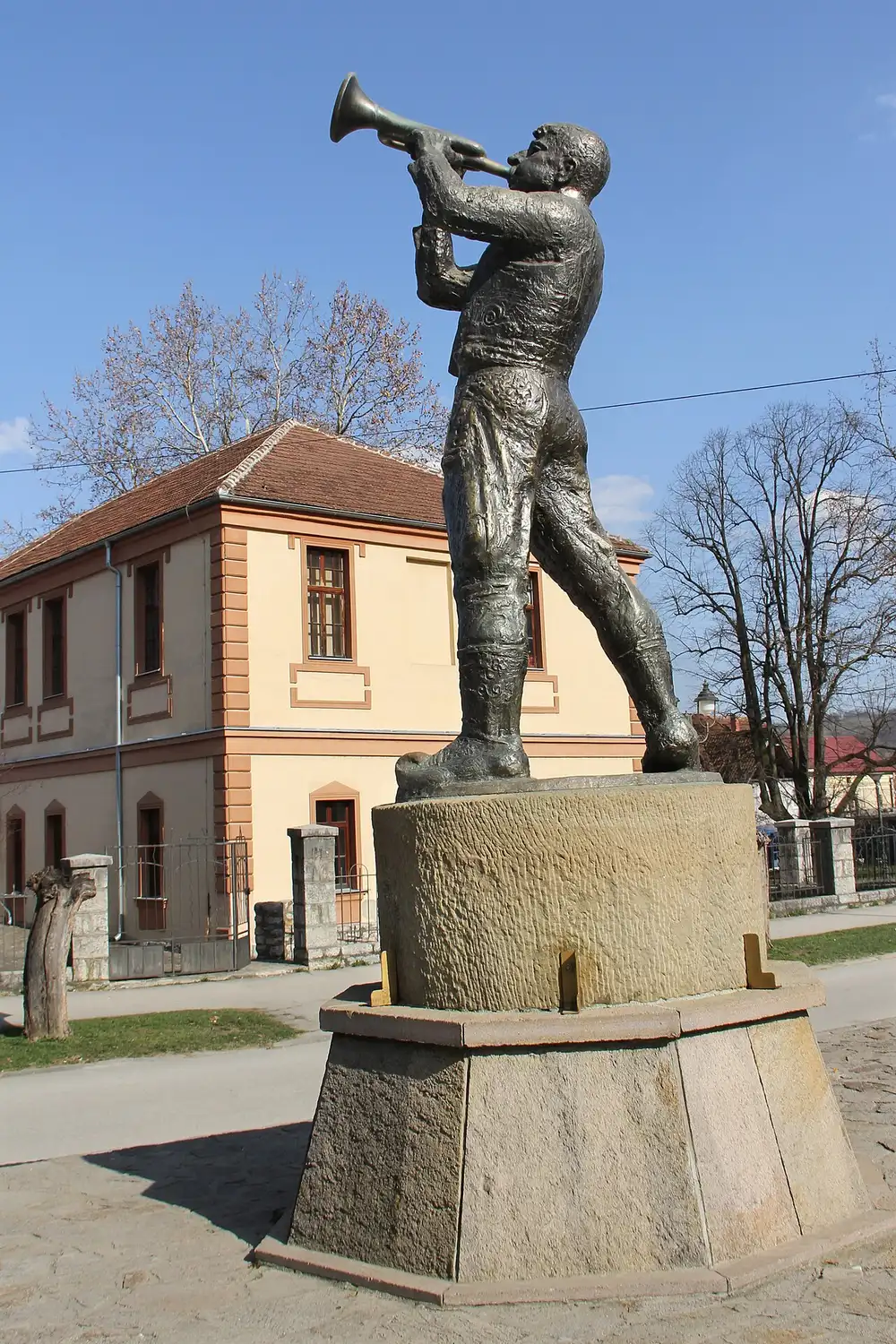 The bronze statue of a trumpet player in the centre of Guča, the village monument to its own brass legend