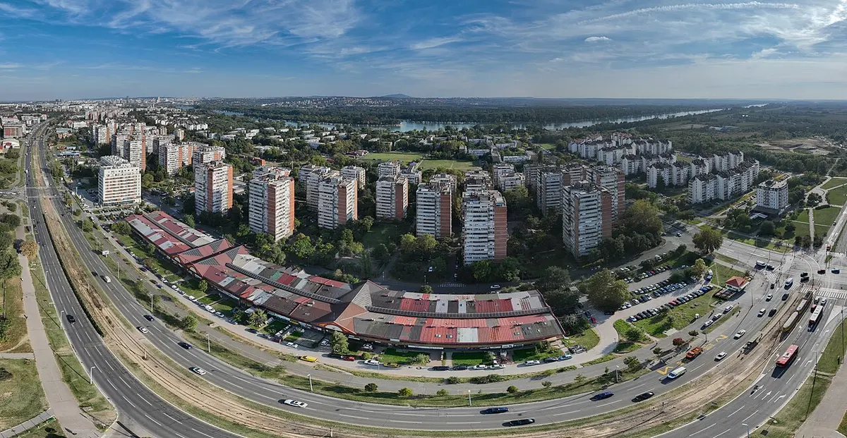 Rows of tall socialist-era residential tower blocks in New Belgrade under a wide sky