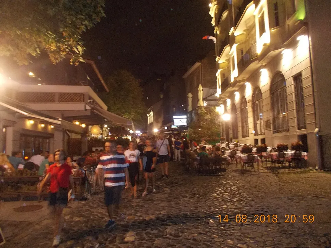 Diners and lit terraces in the cobbled Skadarlija old quarter of Belgrade in the evening