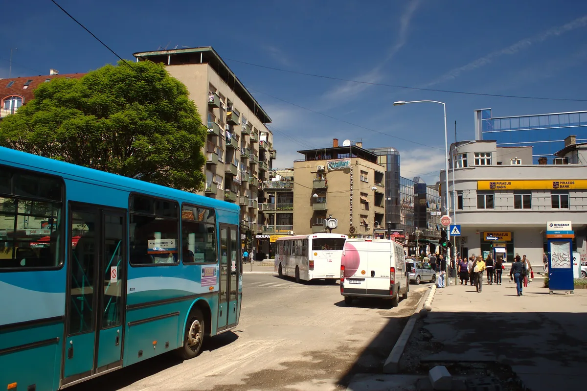 A city bus in central Niš on a busy street, of the kind that runs the free airport line 34
