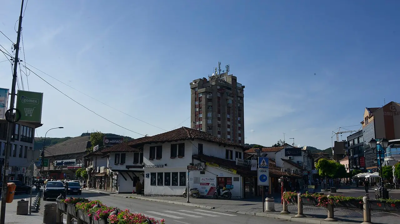 A street in central Novi Pazar with low Ottoman-era buildings under a socialist-era tower block