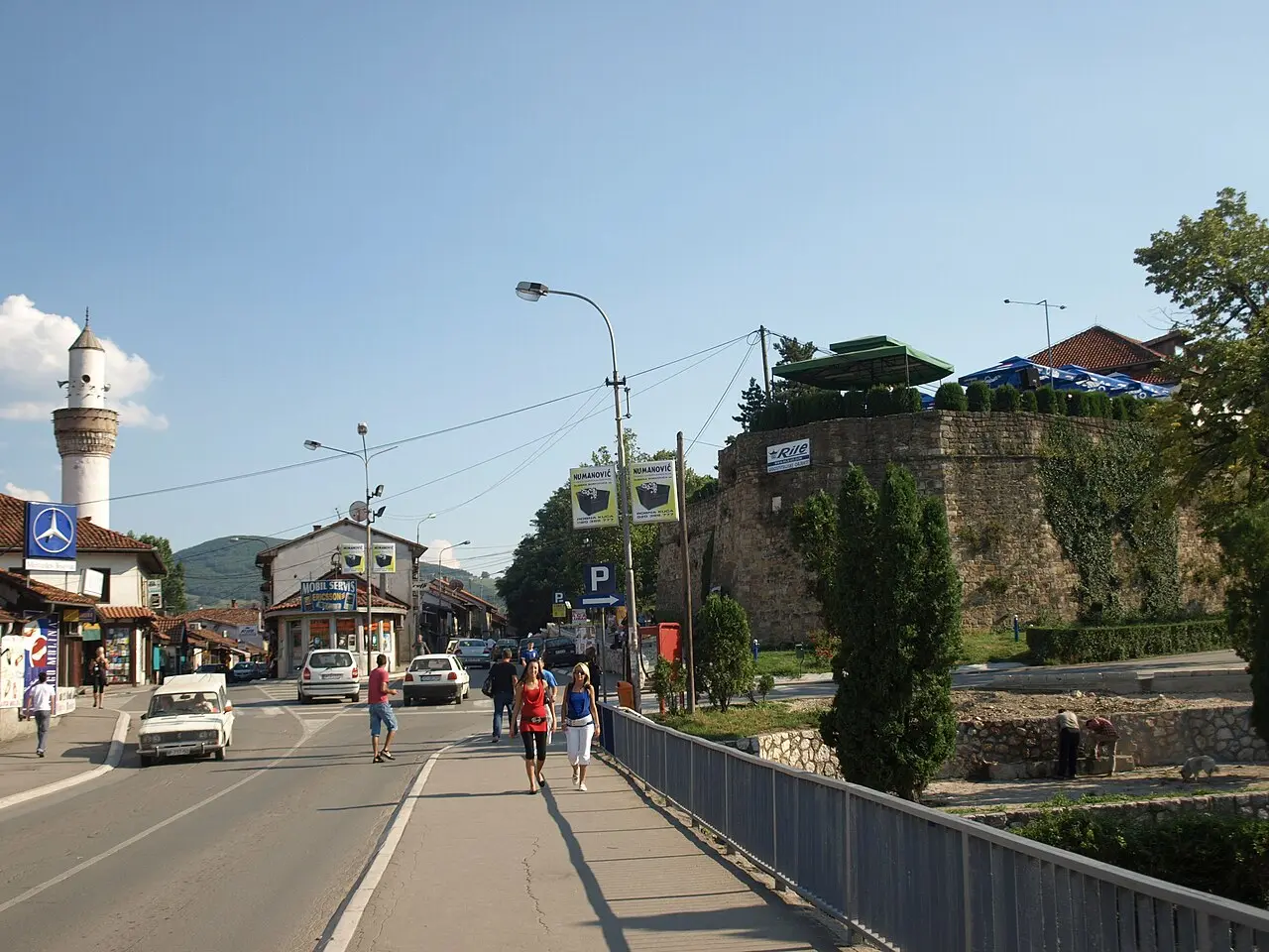 A street in Novi Pazar with a minaret on one side and the wall of the old fortress on the other
