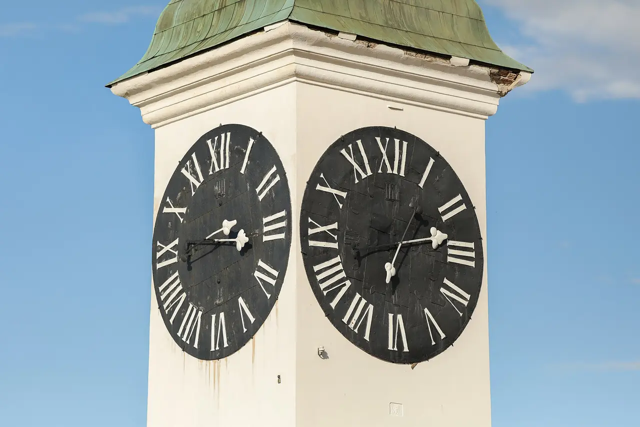 The Petrovaradin clock tower with its two black faces, the large hand pointing to the hour and the small hand to the minutes