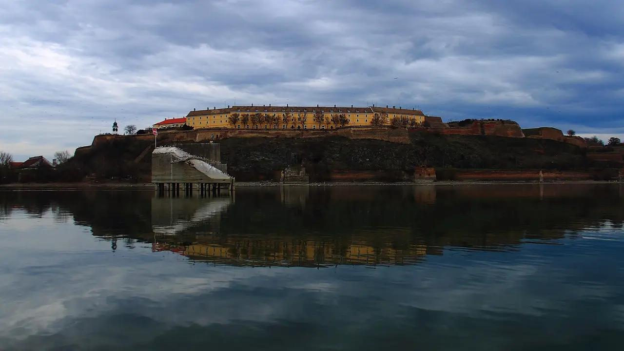 Petrovaradin Fortress and its baroque barracks on the rock above the Danube, the clock tower at left, reflected in the river