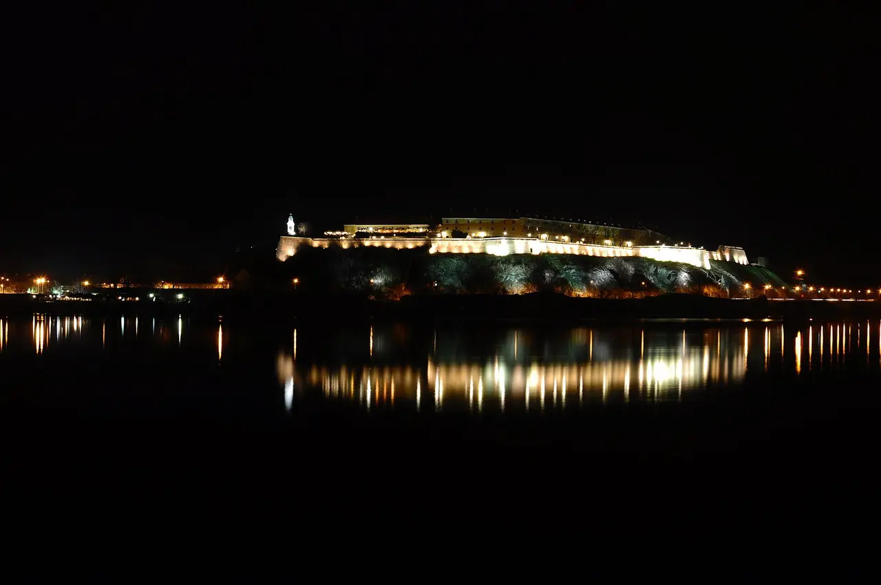 Petrovaradin Fortress floodlit at night above the Danube, the fortress that hosted the EXIT festival for 25 years