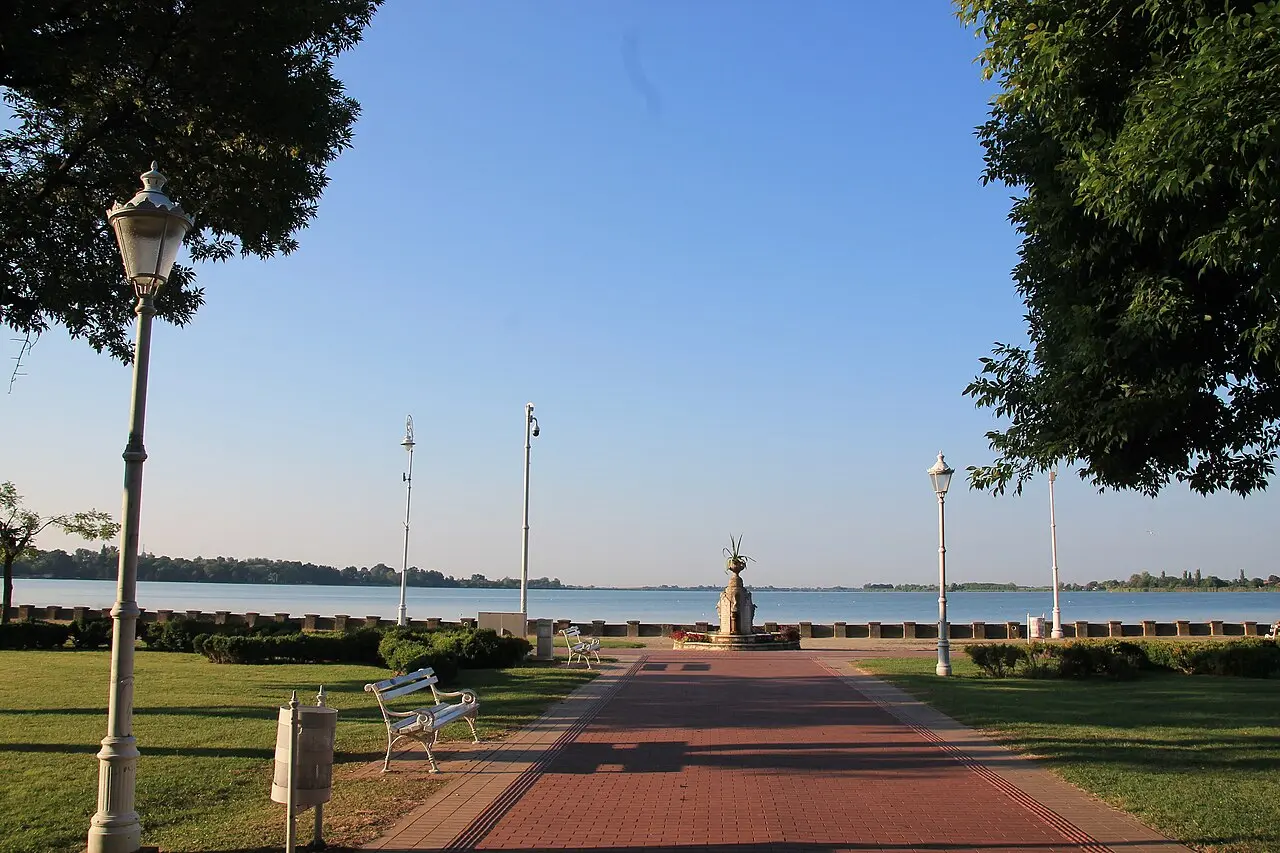 The brick promenade at Palic leading between lamp posts to the memorial fountain and the open lake