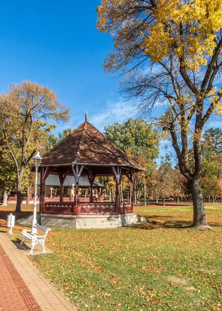 The red timber music pavilion at Palic among trees in autumn colour