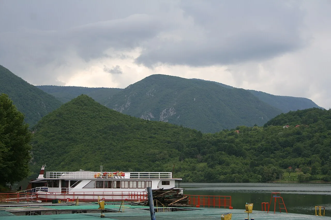 The long green Drina lake at Perućac in western Serbia, forested hills rising on both banks