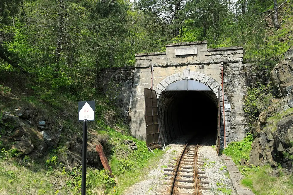 A narrow-gauge train at the west portal of the Šargan tunnel, the high point of the line