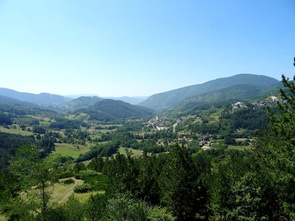 The green Mokra Gora valley, home of the Šargan Eight railway, seen from the hillside